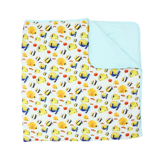 Children's blanket with fish and coral pattern on a white background