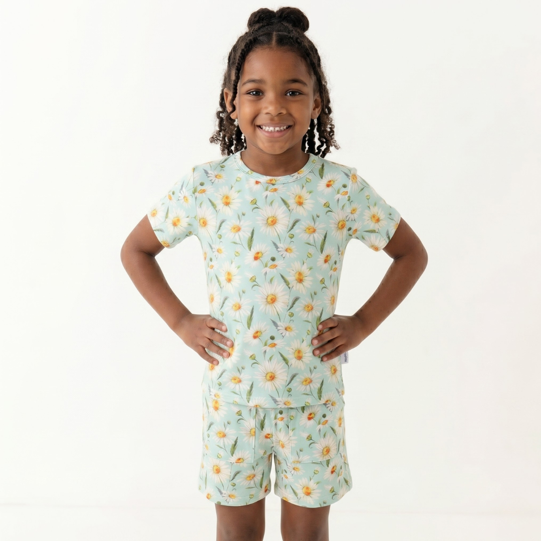 Child wearing a floral pajama set on a white background