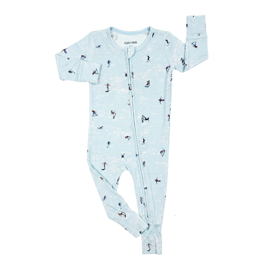 A baby long-sleeve footed sleeper in light blue with a repeating print of penguins, shown flat on a white background.