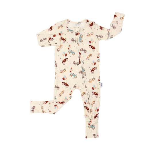 A baby long-sleeve footless one-piece sleeper with a cream background and an all-over print of small vintage cars in brown, red, and light blue, shown flat on a white background.