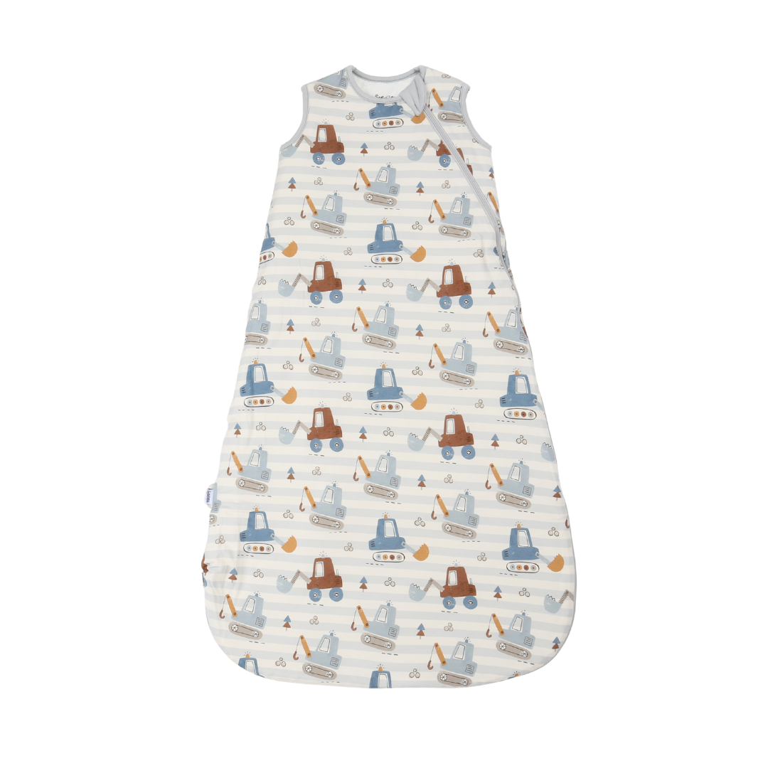 A baby sleep sack with a white and light blue striped background, featuring an all-over print of cartoon construction vehicles in brown and blue, set against a plain white background.