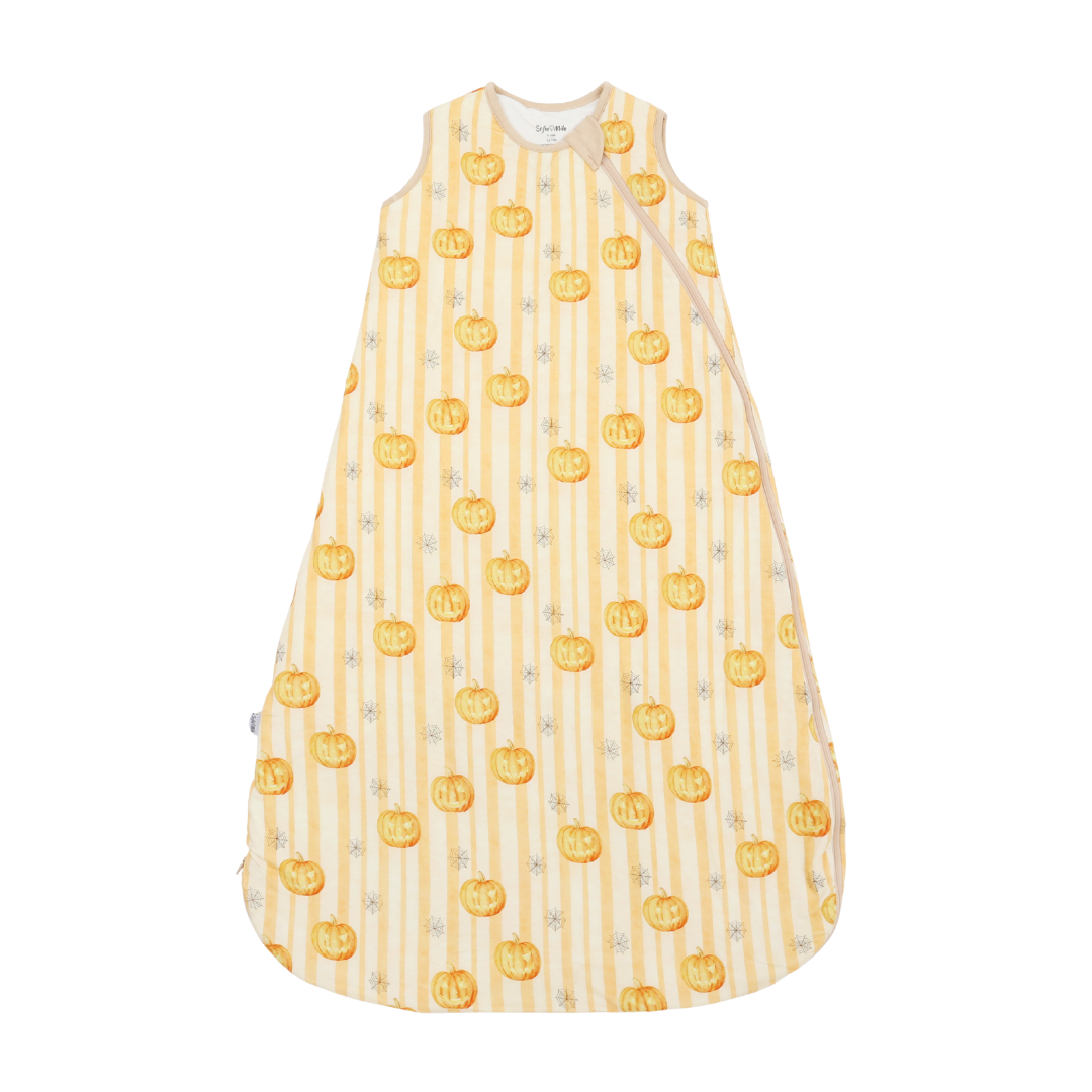 A sleeveless baby sleep sack with a vertical cream and yellow stripe pattern, decorated with orange jack-o'-lantern pumpkins and small gray stars, shown flat against a white background.