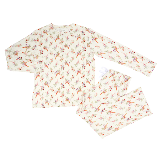 A two-piece long-sleeve pajama set featuring a cream-colored fabric with an all-over delicate floral and berry print in muted red, orange, and green tones, laid flat on a white background.