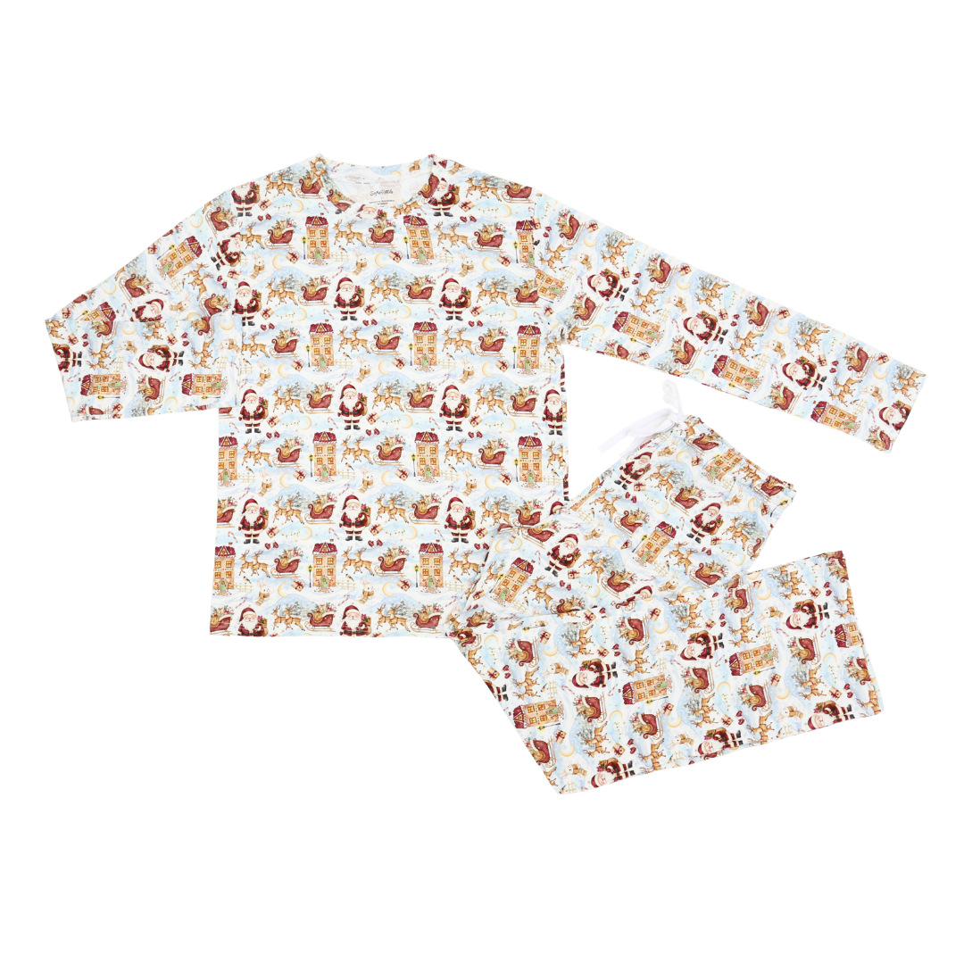 A two-piece long-sleeve pajama set with an all-over festive holiday print featuring Santa Claus, reindeer, gingerbread cookies, and snowflakes on a white background.