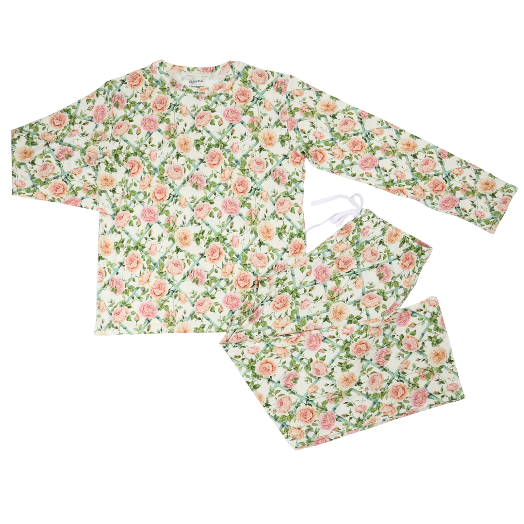 A two-piece pajama set featuring a long-sleeve top and matching pants with an all-over floral print of pink roses and green leaves on a white background.