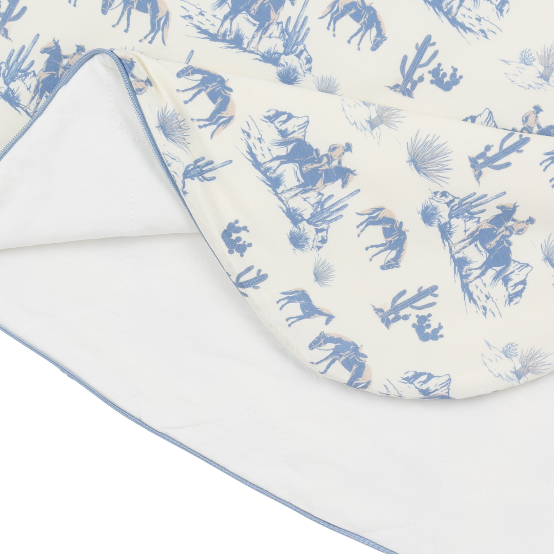 Baby blanket with blue horse and rider pattern on a white background