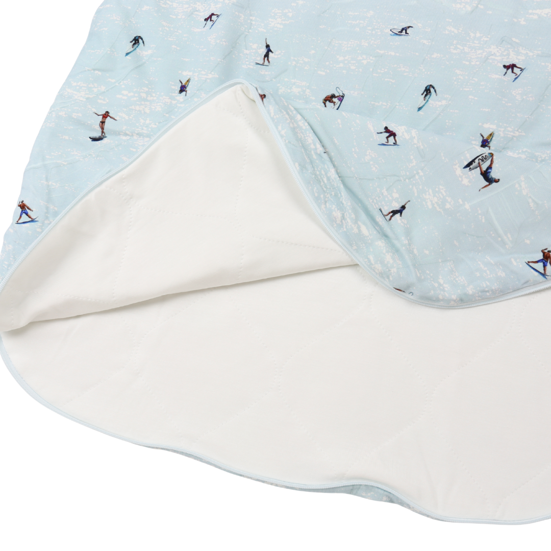 Baby blanket with skier pattern on a light blue background