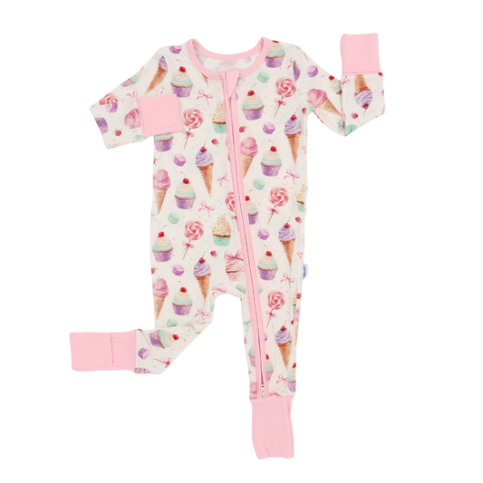Baby onesie with ice cream cone and cupcake pattern on a white background