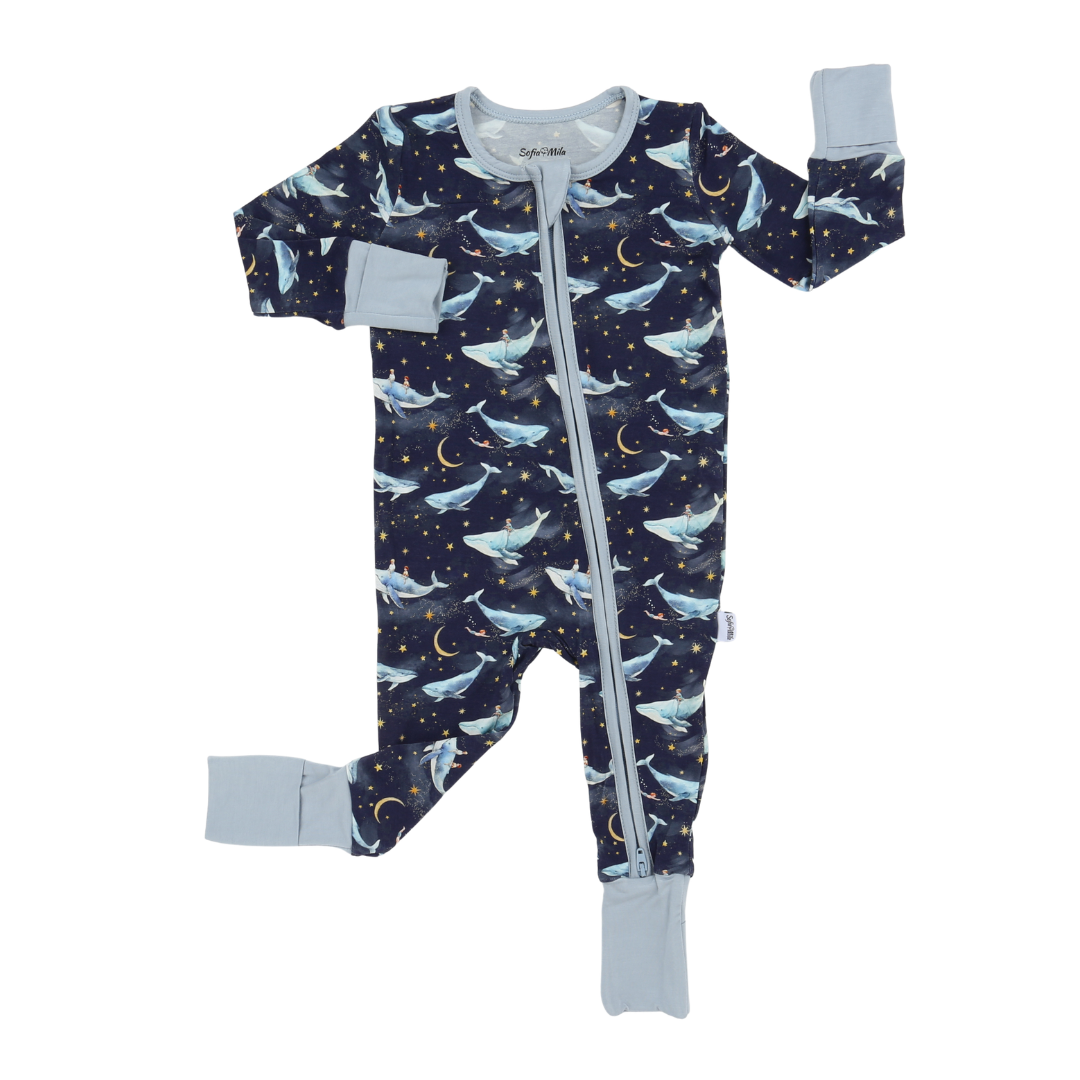 Baby onesie with whale and moon pattern on a white background