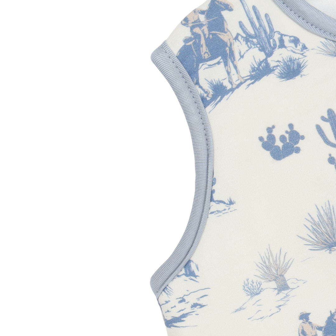 Baby romper with blue desert pattern on a white background