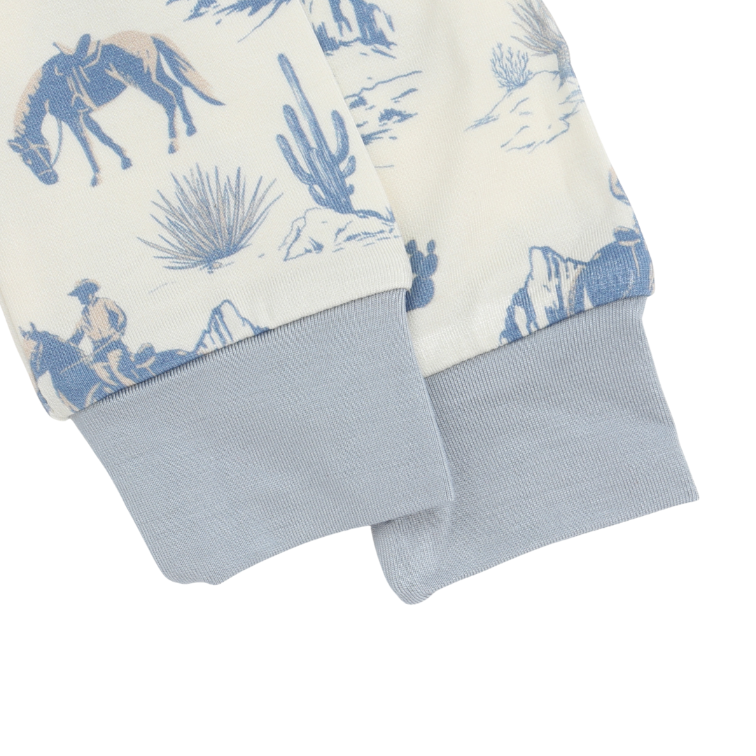 Baby romper with cowboy and desert pattern on a white background