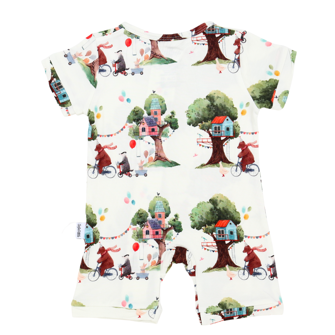 Children's outfit with a colorful treehouse pattern on a white background