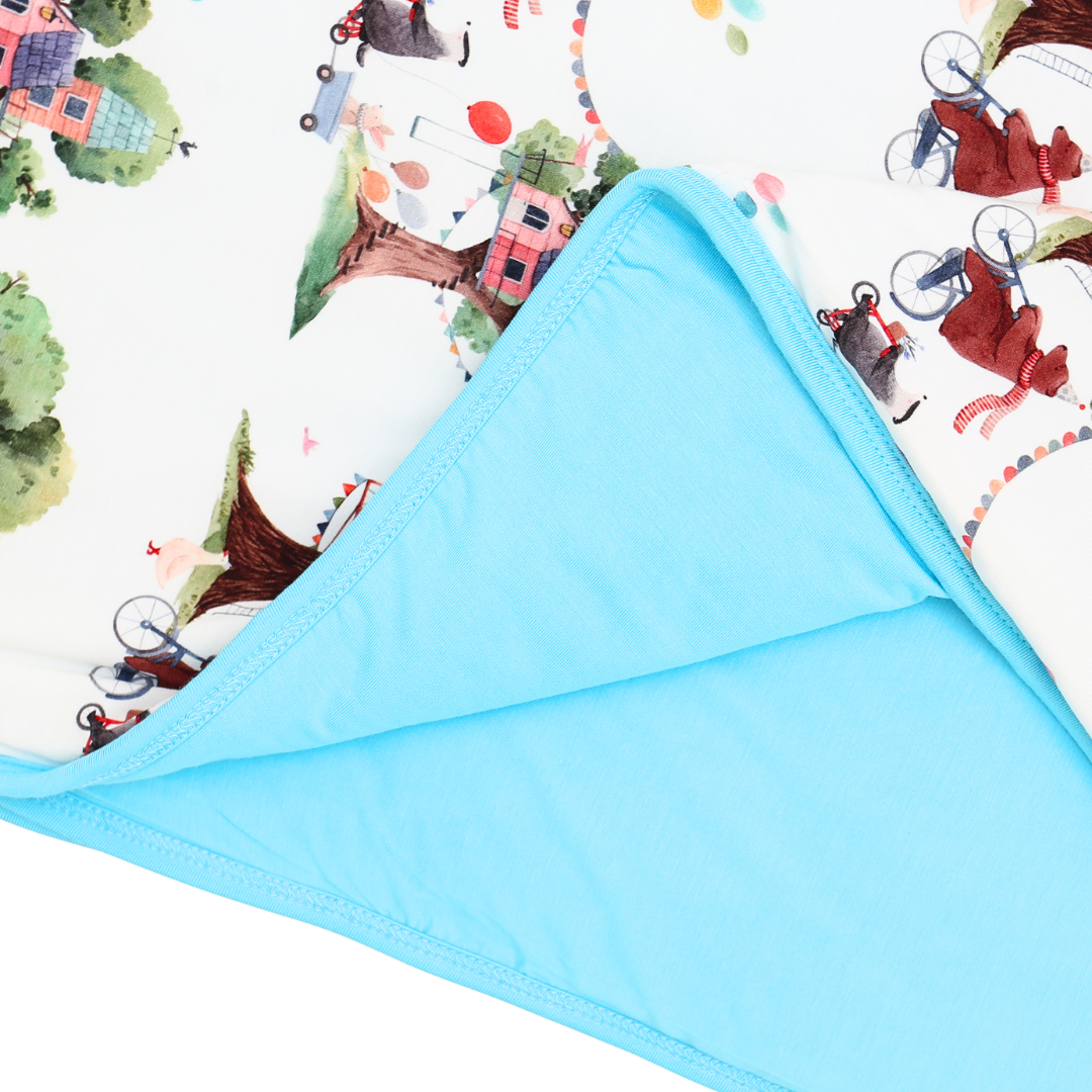 Blue fabric with cartoon characters and scenes on a white background