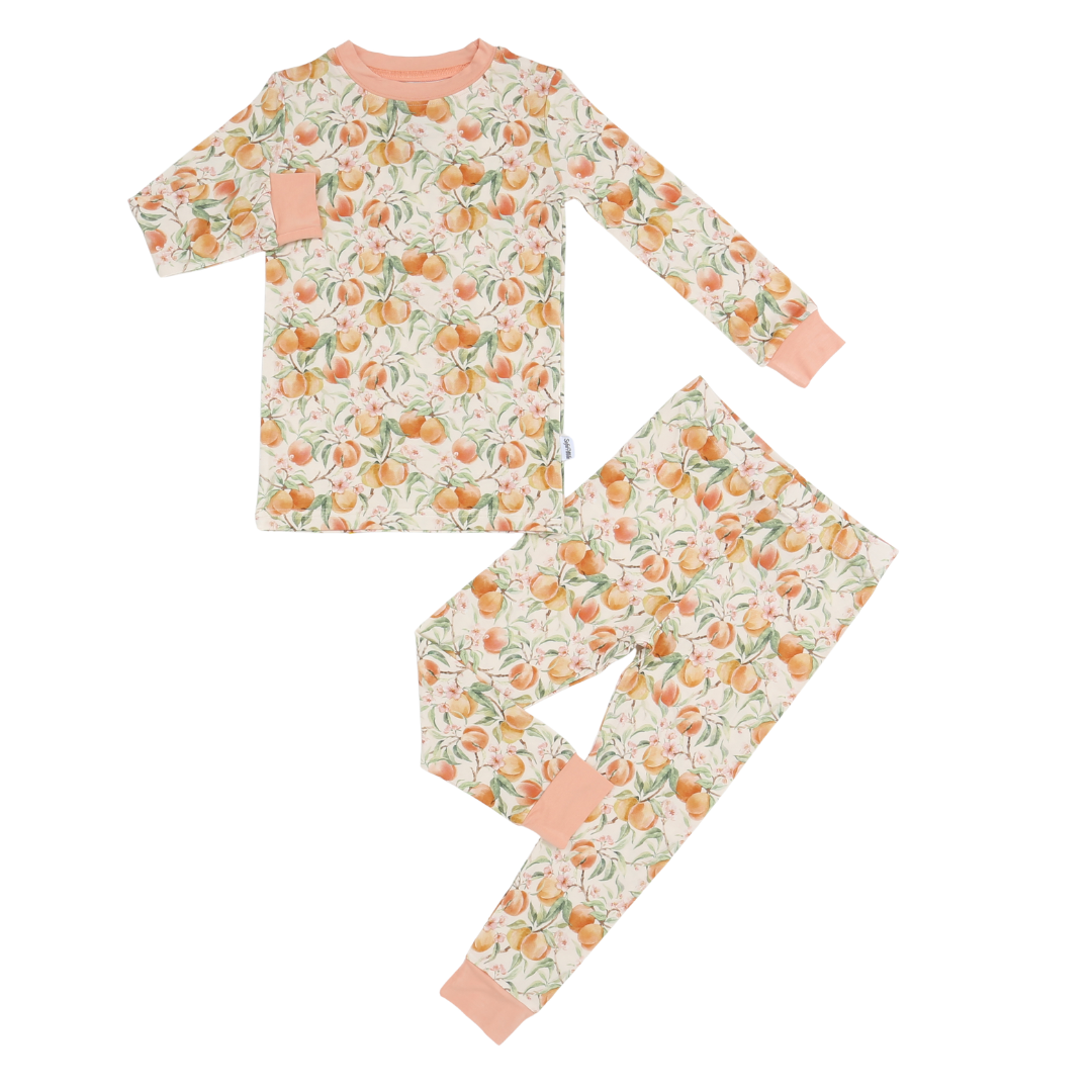 Children's pajama set with peach pattern on a white background