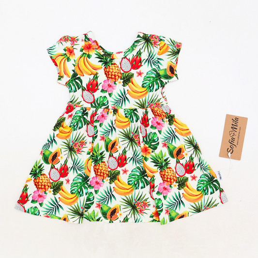 Children's dress with tropical fruit pattern on a white background