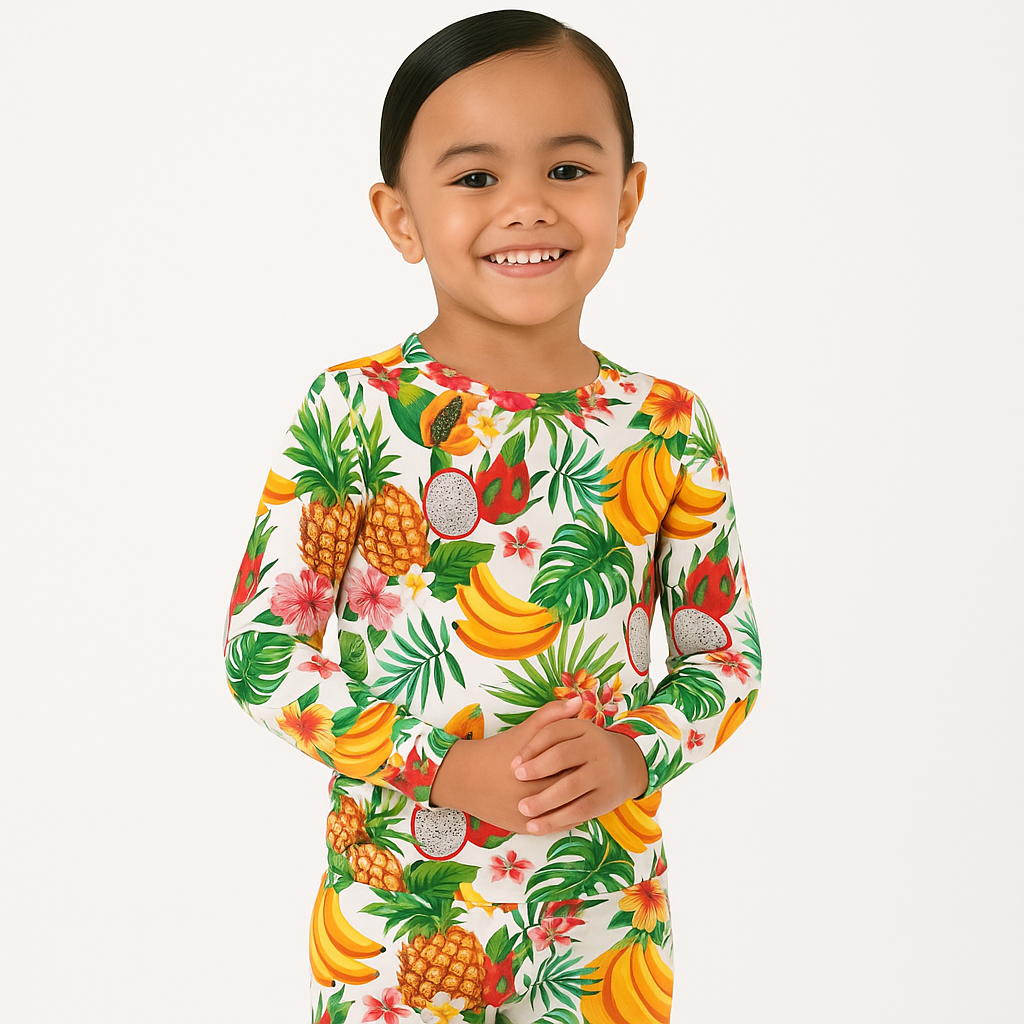 Child wearing a colorful fruit-themed onesie on a white background