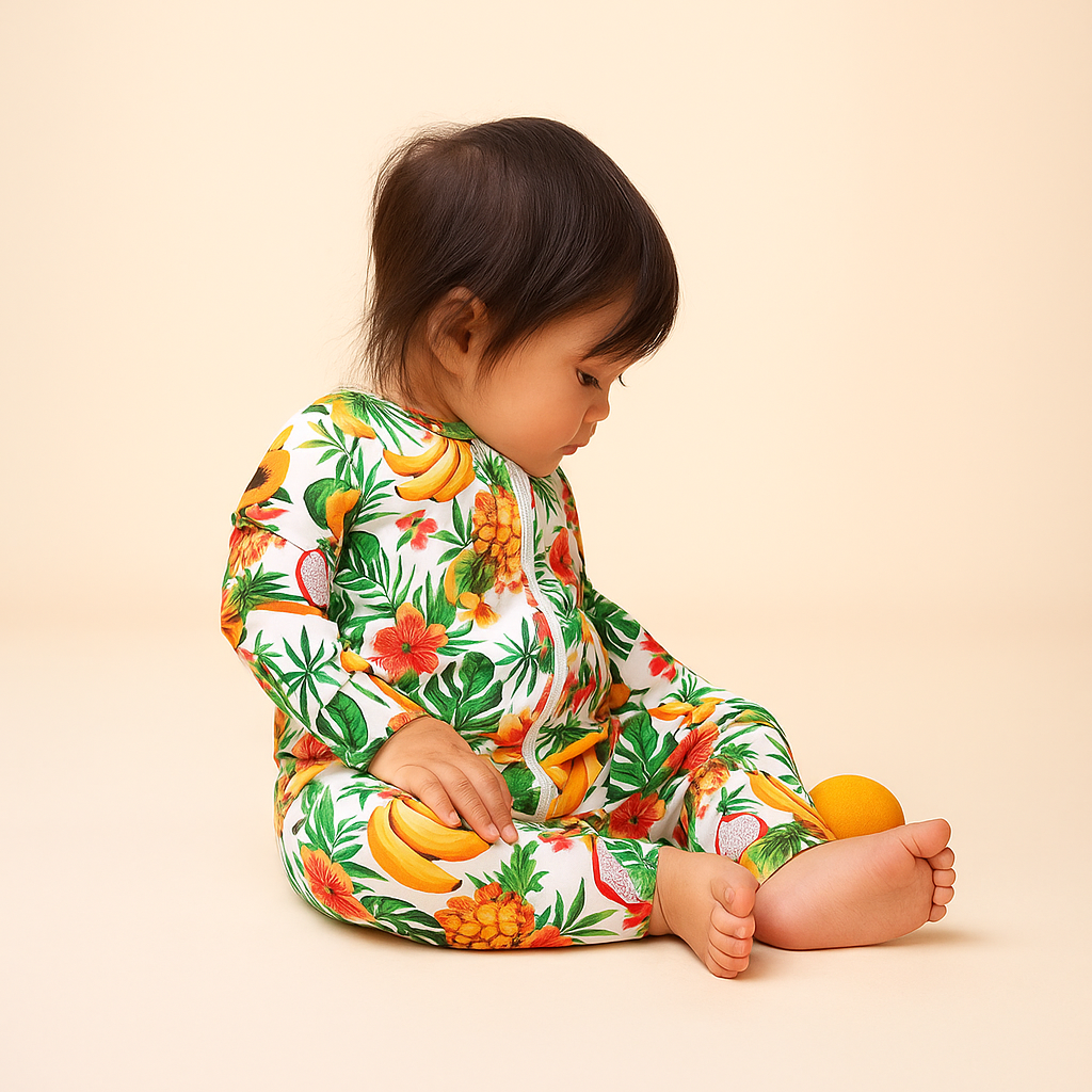 Child wearing a colorful fruit-patterned onesie on a beige background