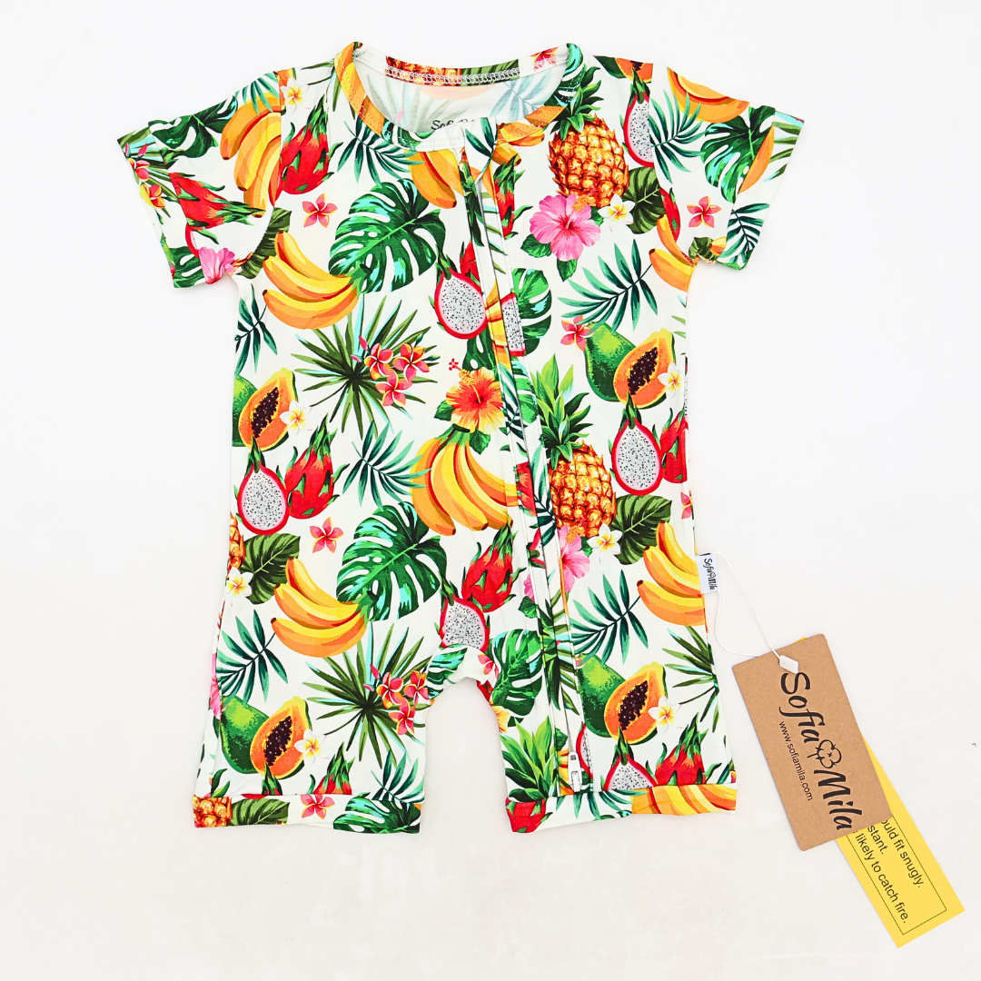 Children's romper with tropical fruit and leaf pattern on a white background