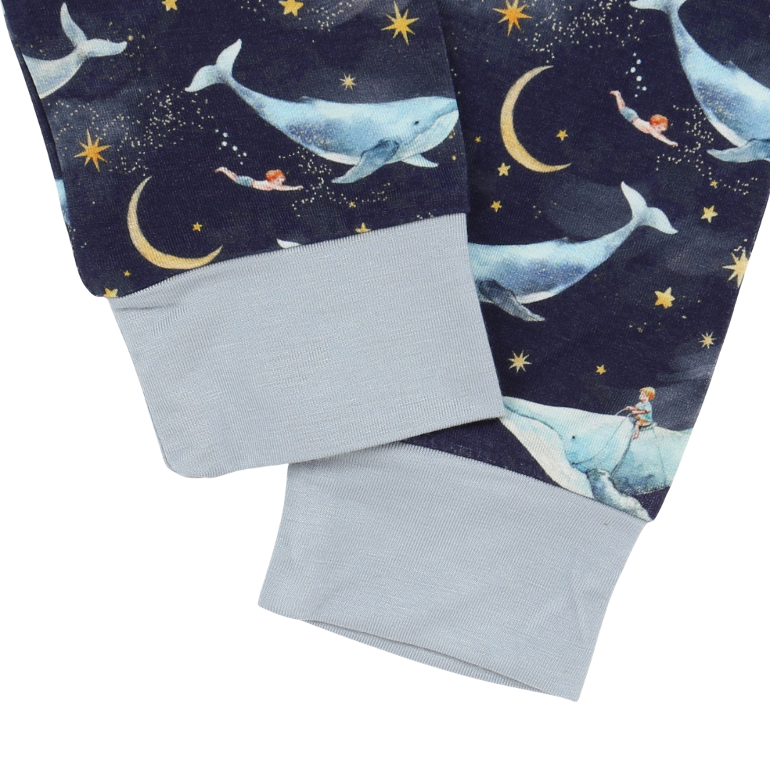 Children's blanket with whale and moon design on a dark blue background