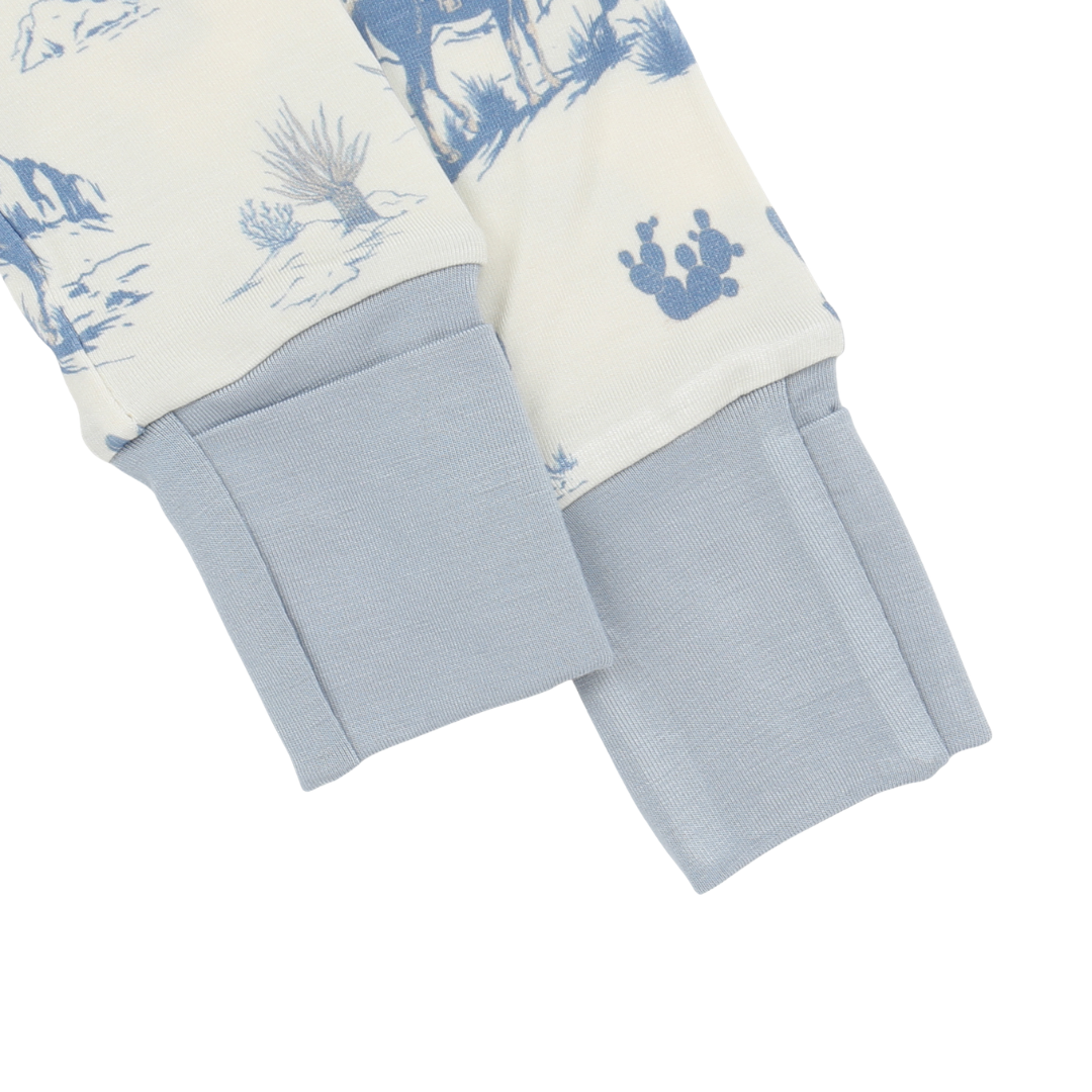 Close-up of a baby outfit with blue and white pattern on a white background