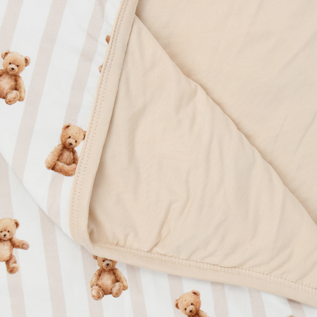 Close-up of a beige fabric with teddy bear pattern