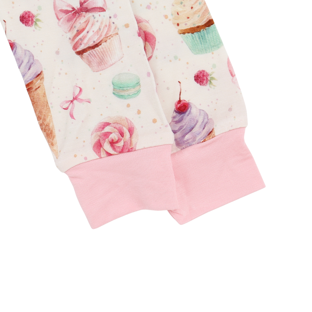 Close-up of a fabric with cupcake and macaron pattern on a white background