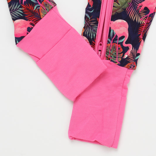Close-up of a pink garment with a colorful flamingo pattern on a white background