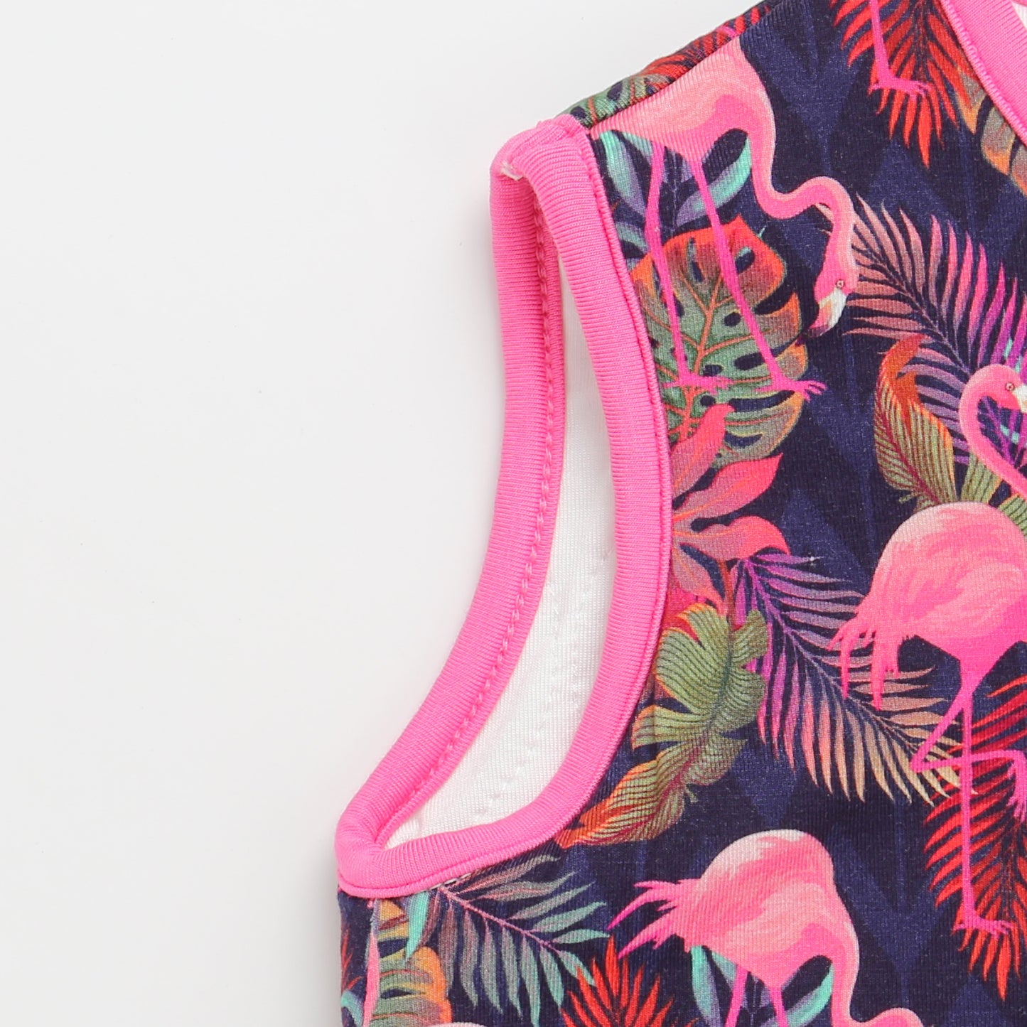 Close-up of a swimsuit with pink flamingo and leaf pattern on a white background