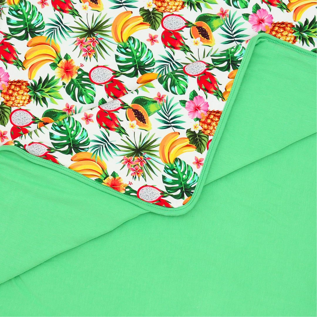 Green fabric with tropical fruit and leaf pattern