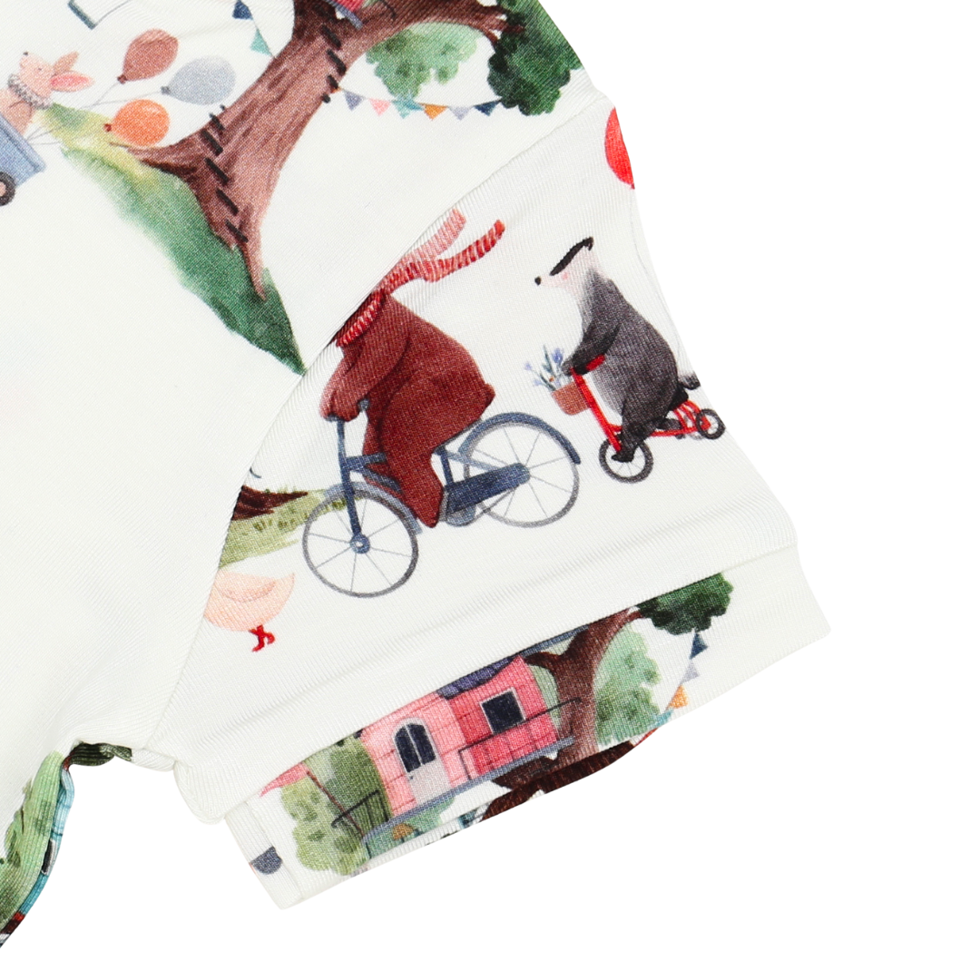 Fabric with a nature-themed design featuring animals and trees on a white background