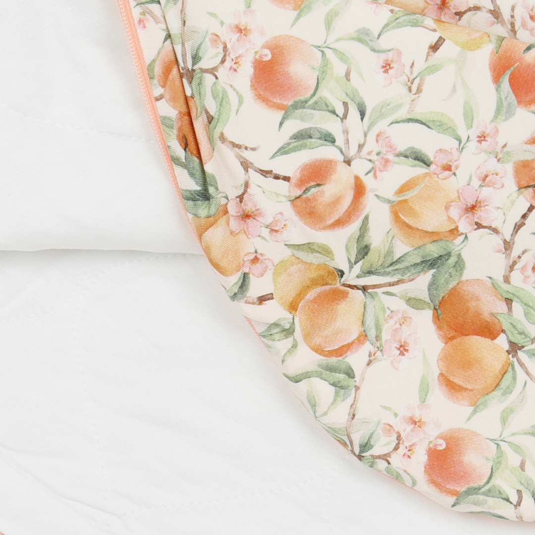 Fabric with peach and floral pattern on a white background