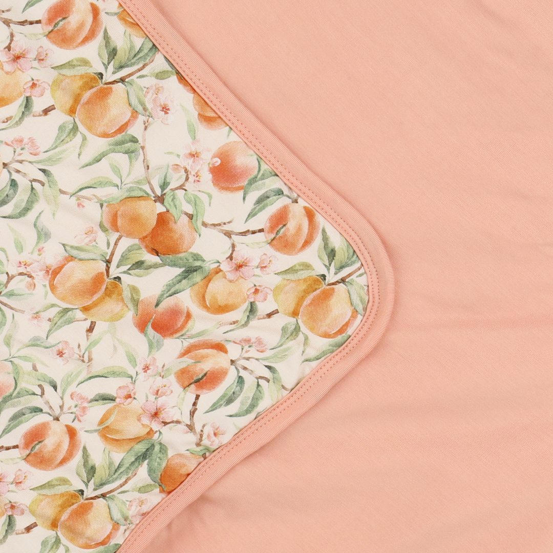 Fabric with peach pattern on a pink background