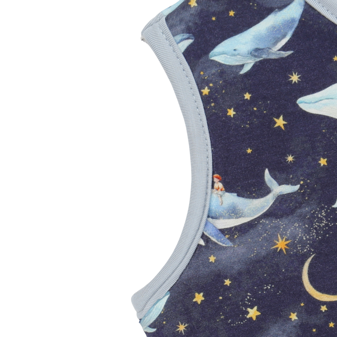 Fabric with whale and star pattern on a dark blue background