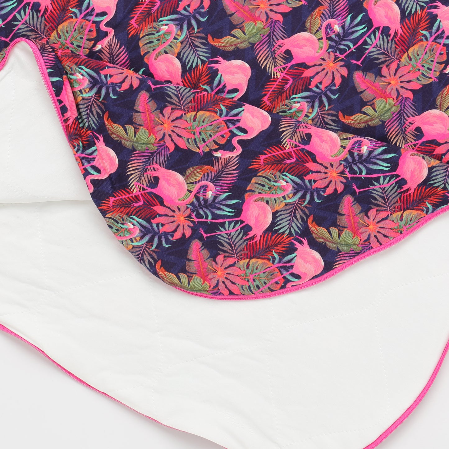 Floral and flamingo patterned fabric on a white background