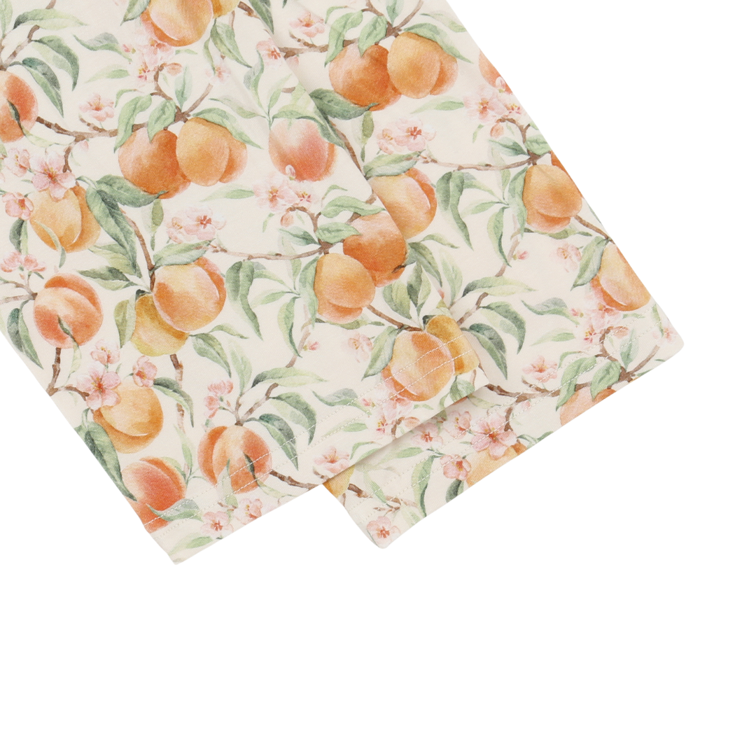 Floral fabric with peach pattern on a white background