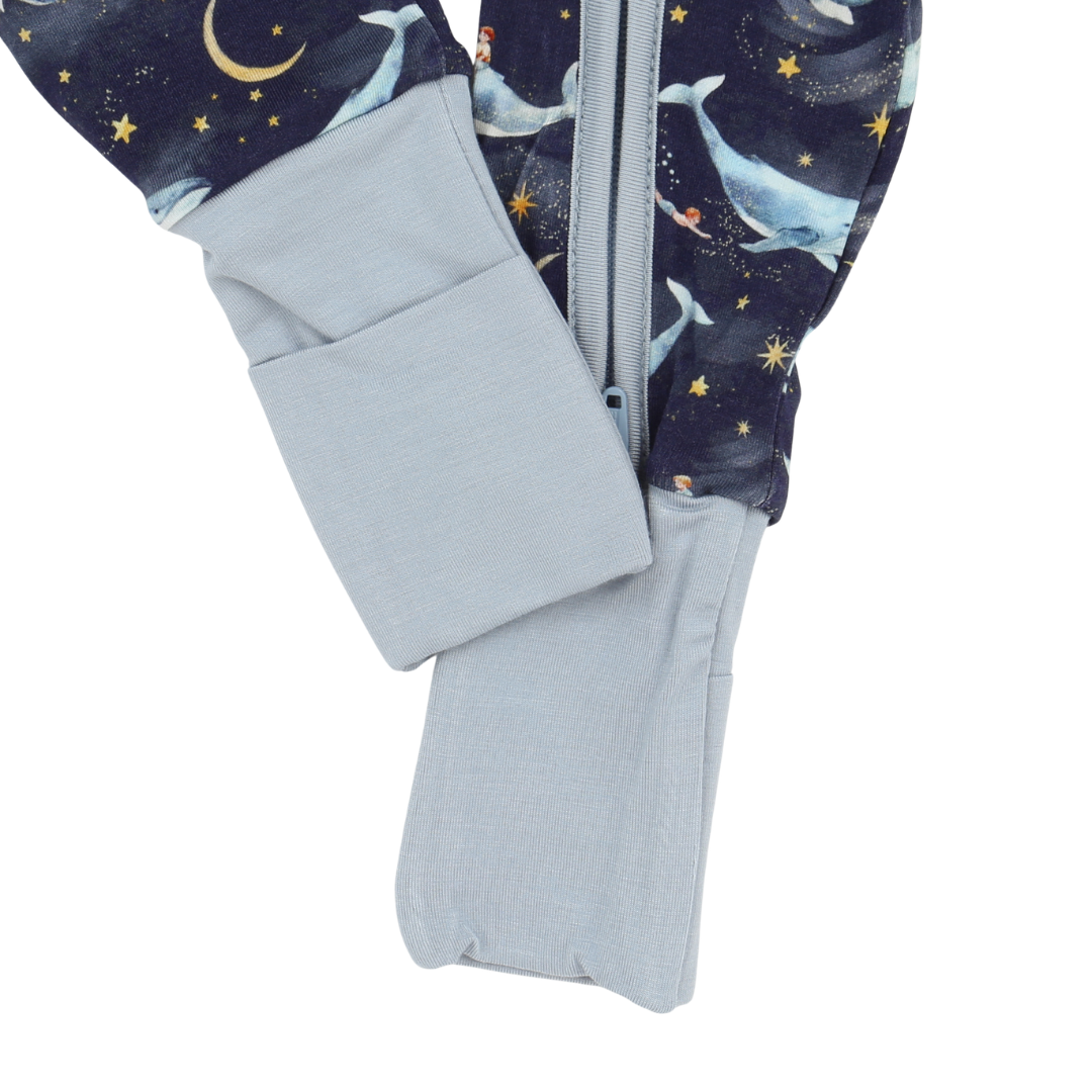 Folded baby blanket with space-themed design featuring stars and moons on a white background