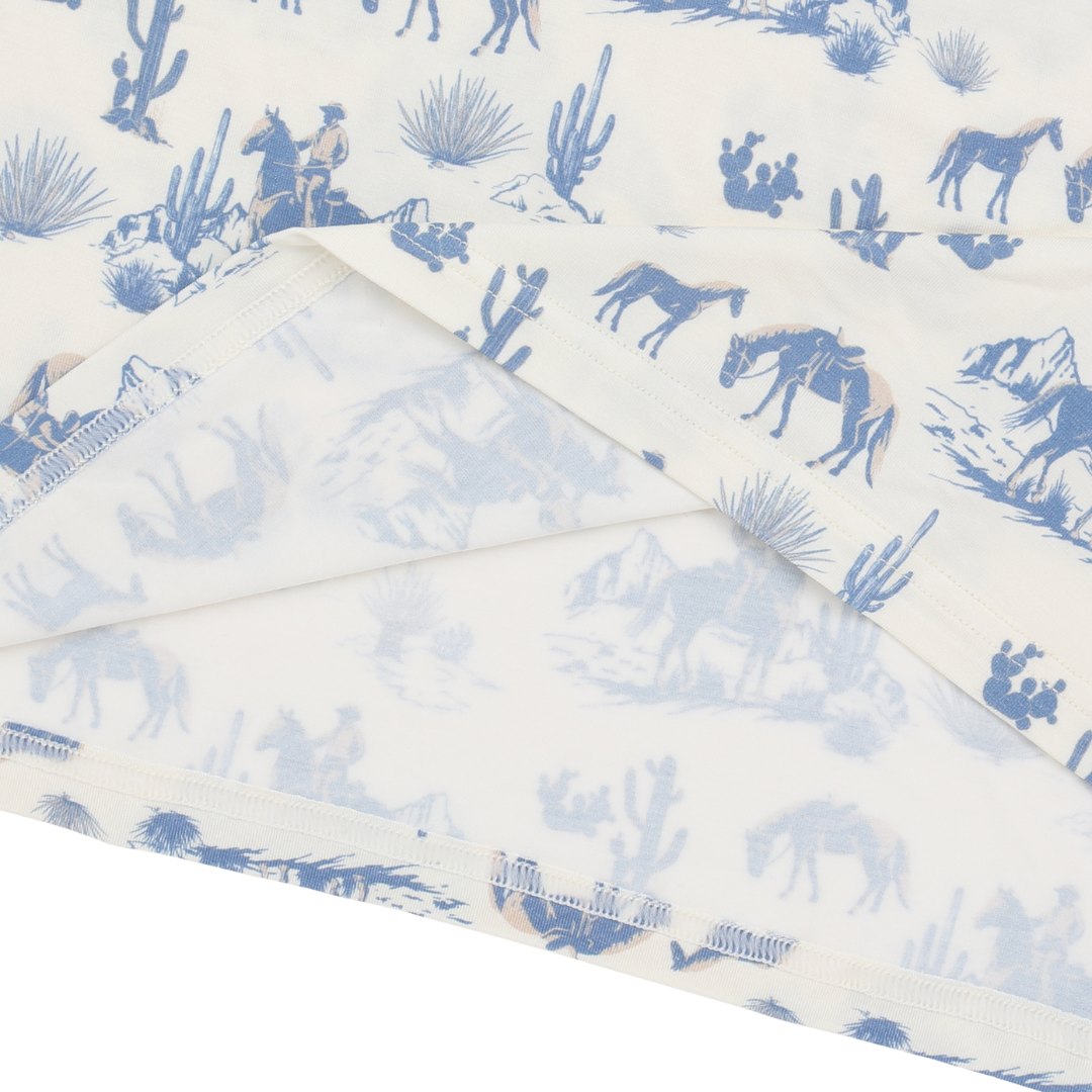 Folded fabric with blue desert scene pattern on a white background