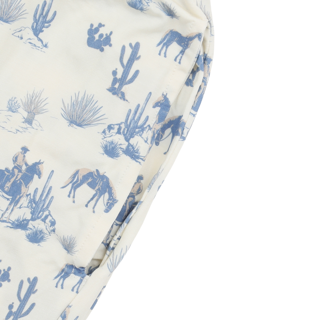 Folded fabric with blue desert scene pattern on a white background
