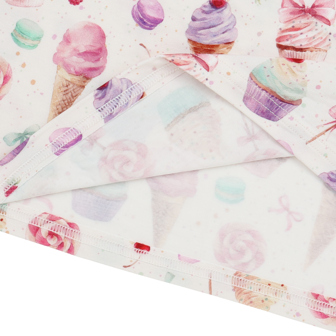 Folded fabric with colorful cupcake pattern on a white background