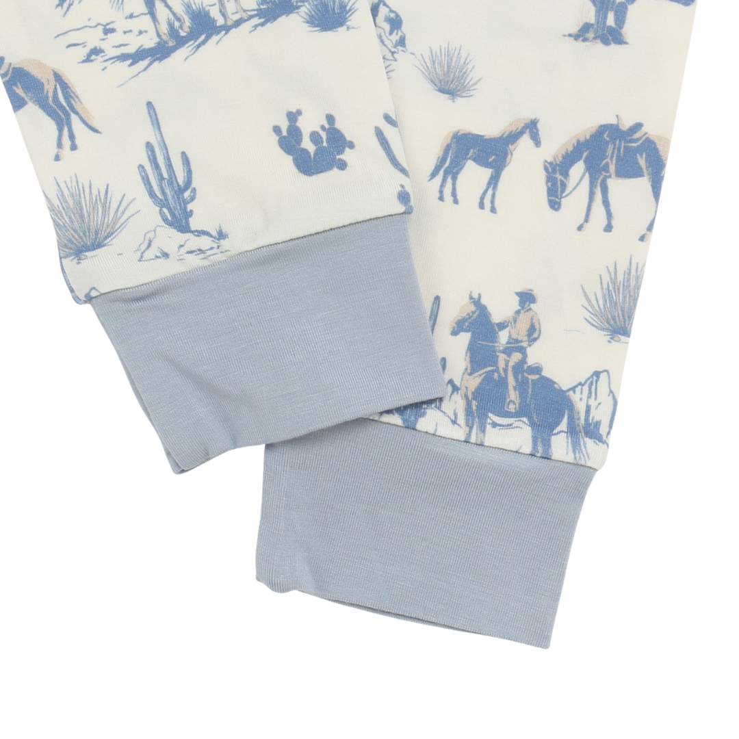 Folded fabric with cowboy and horse pattern on a white background