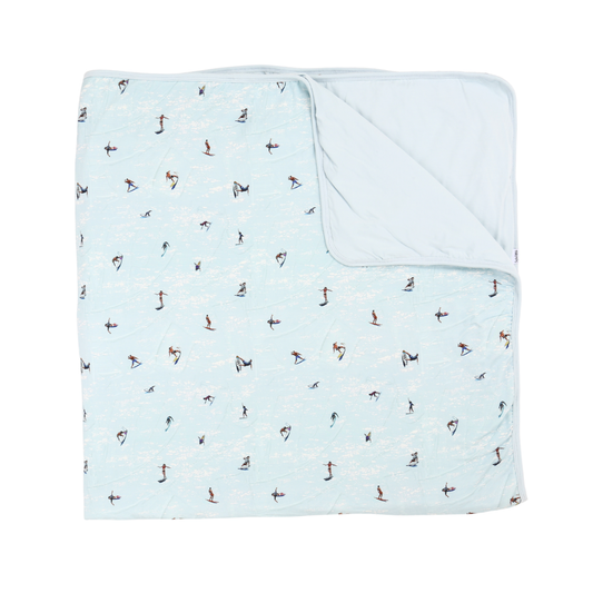 Light blue blanket with small pattern on a white background