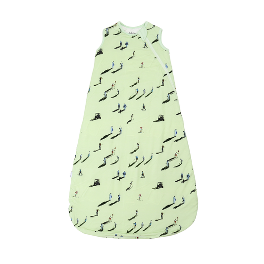Light green baby sleeping bag with black and blue patterns on a white background