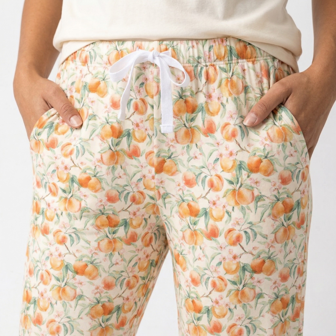 Pajama pants with peach pattern on a plain background