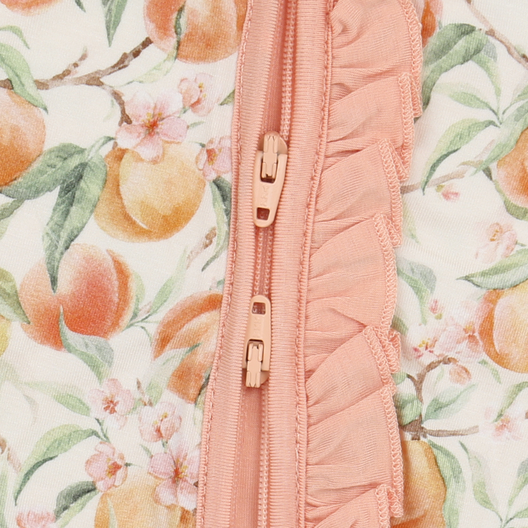 Pink zipper on a background with peach and floral pattern