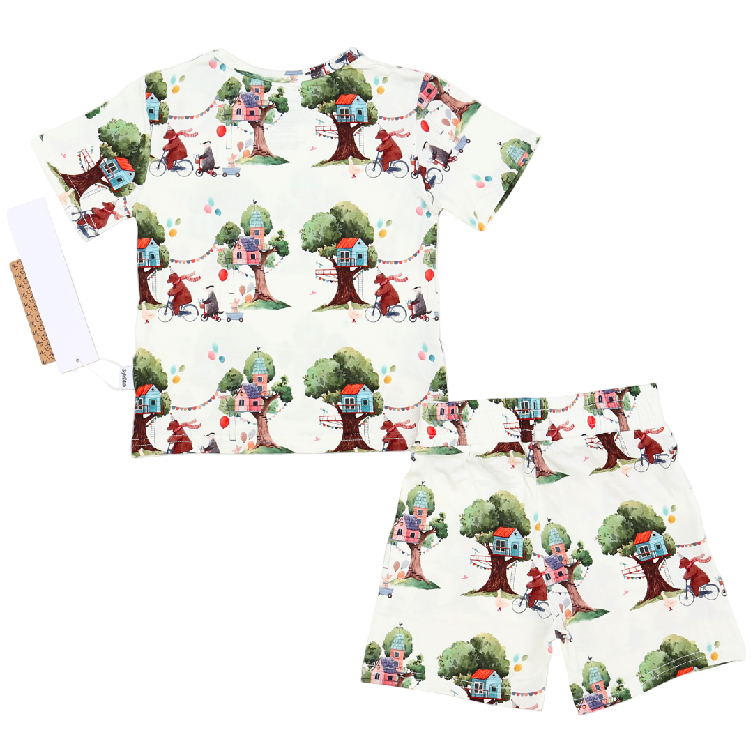 Children's pajama set with tree house design on a white background