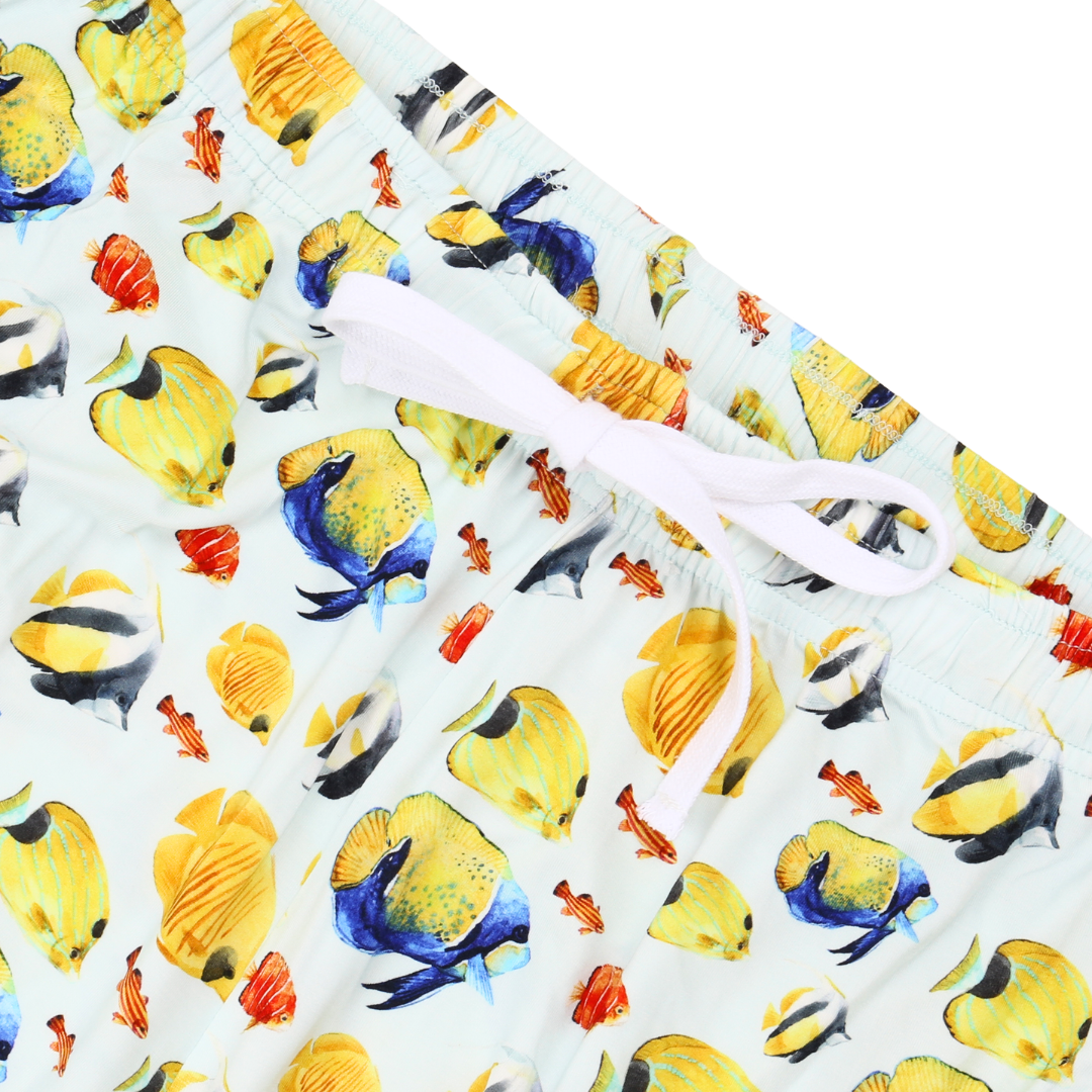 Swim trunks with tropical fish pattern on a white background
