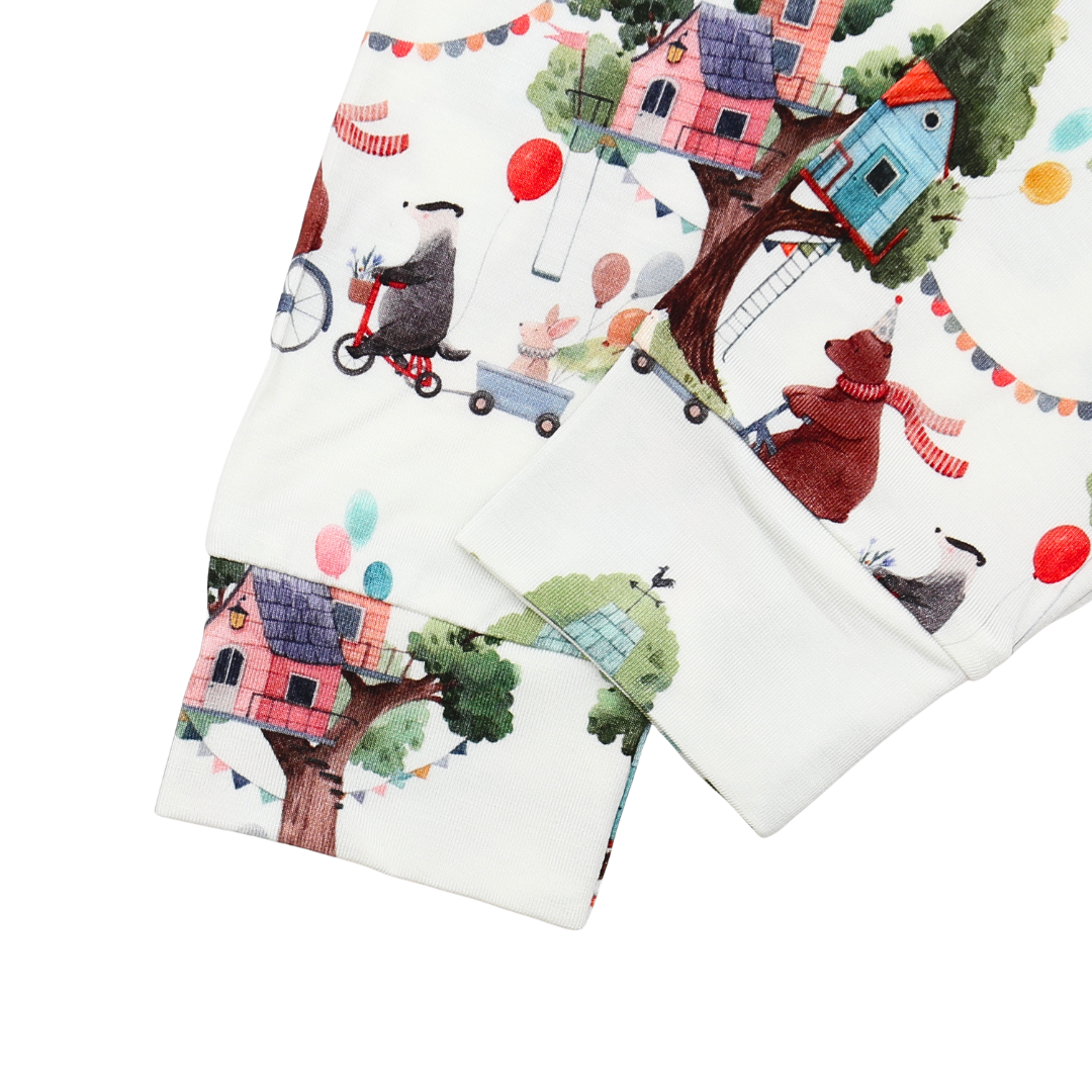 Two fabric panels with cartoon animal designs and houses on a white background