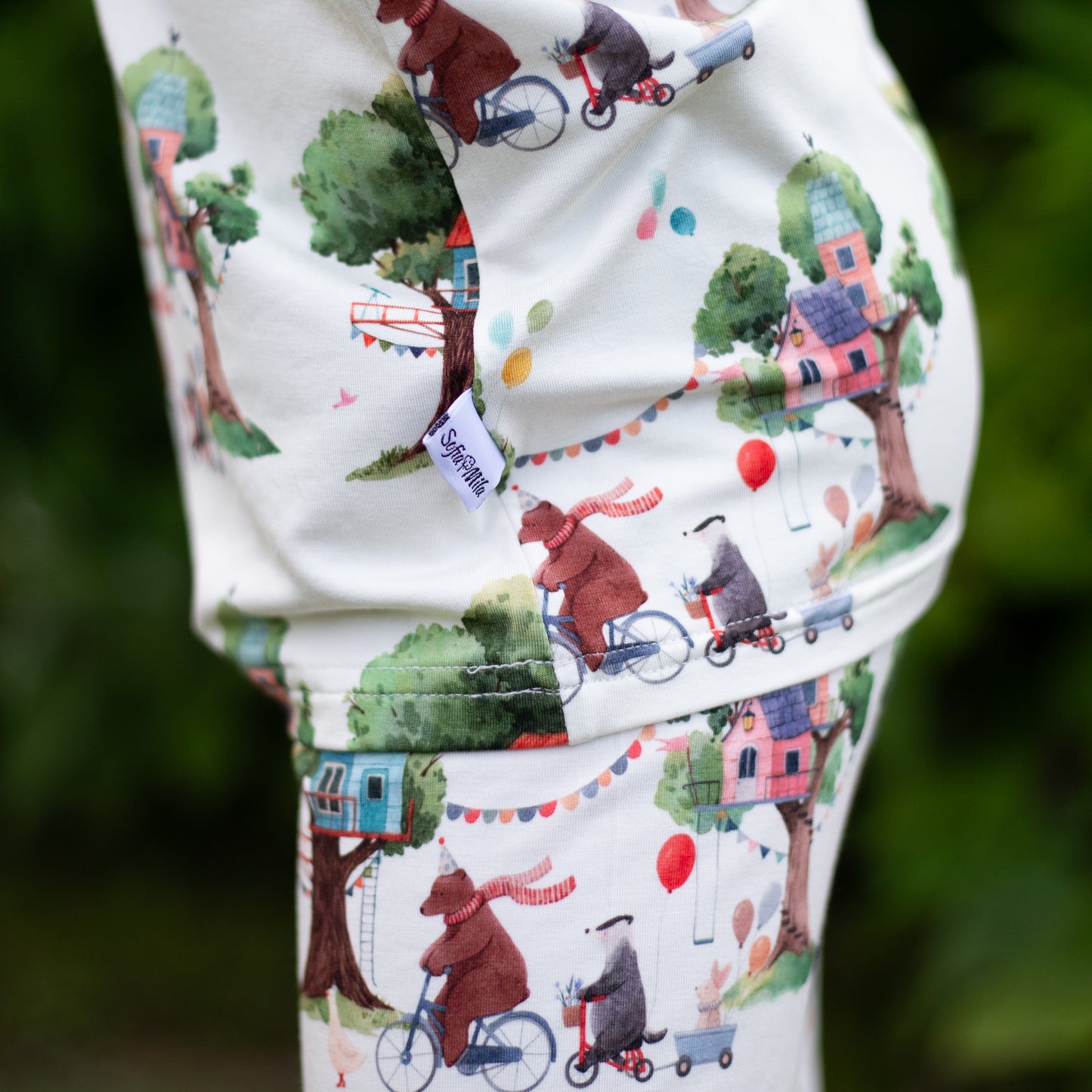 Children's outfit with a bear and bicycle pattern on a white background