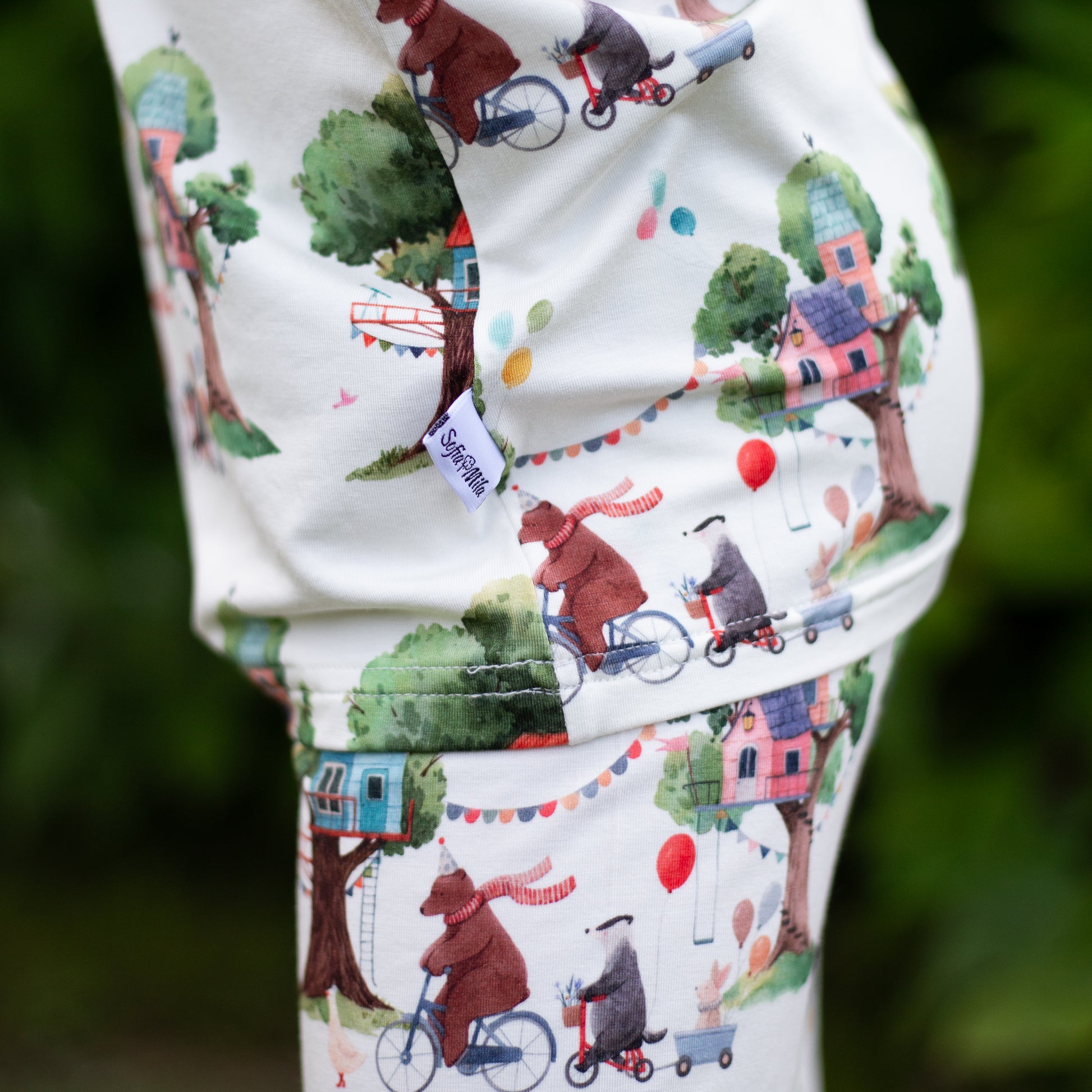 Children's outfit with a bear and bicycle pattern on a white background